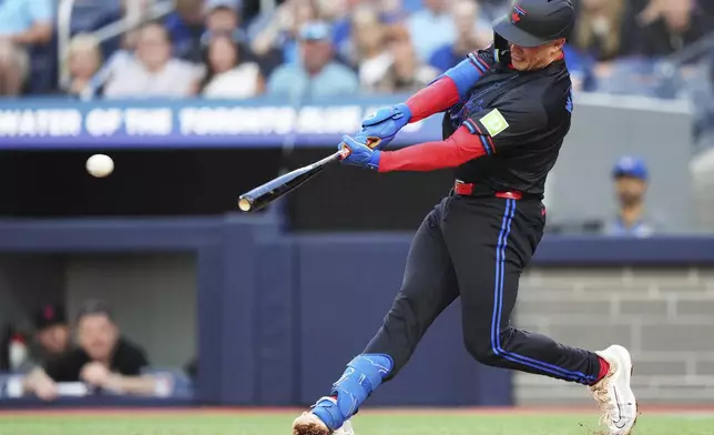 Toronto Blue Jays' Will Wagner (7) hits a two-run double against the San Francisco Giants during second inning MLB baseball action in Toronto on Friday, July 18, 2025. (Nathan Denette/The Canadian Press via AP)