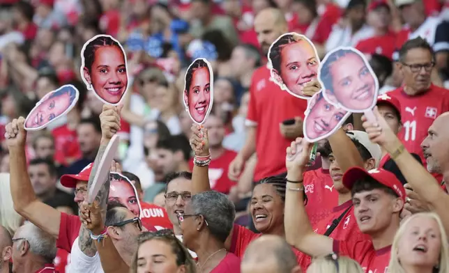 Switzerland fans hold pictures of Switzerland's Iman Beney during the Euro 2025, group A, soccer match between Finland and Switzerland at Stade de Geneve in Geneva, Switzerland, Thursday, July 10, 2025. (AP Photo/Alessandra Tarantino)