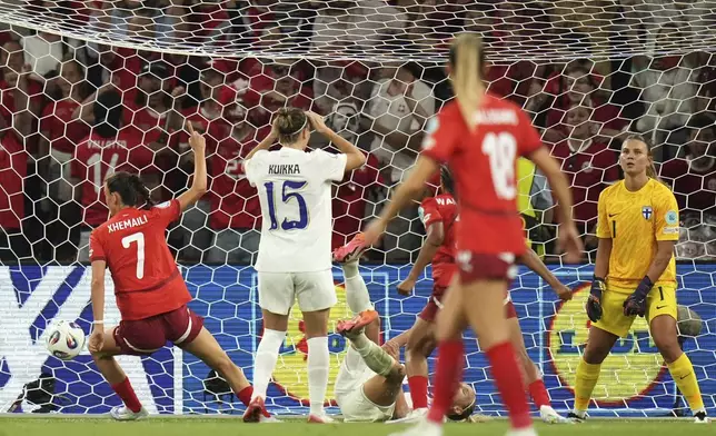 Switzerland's Riola Xhemaili, left, celebrates after scoring her side's first goal during the Euro 2025, group A, soccer match between Finland and Switzerland at Stade de Geneve in Geneva, Switzerland, Thursday, July 10, 2025. (AP Photo/Alessandra Tarantino)
