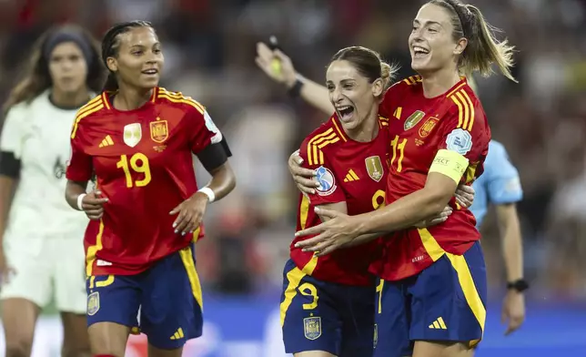 Spain's Alexia Putellas, right, celebrates scoring with Esther Gonzalez, center, and Vicky Lopez during the Euro 2025, group B, soccer match between Spain and Portugal at Stadion Wankdorf in Bern, Switzerland, Thursday, July 3, 2025. (Peter Klaunzer/Keystone via AP)
