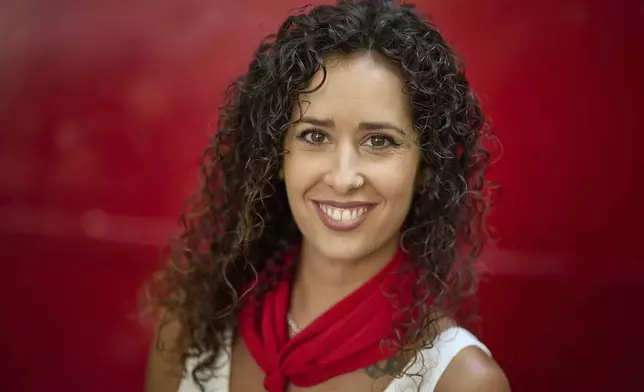 CORRECTS OMARA TO YOMARA - Bull-runner Yomara Martinez poses for a portrait during the San Fermín festival in Pamplona, northern Spain, on Friday, July 11, 2025. (AP Photo/Miguel Oses)