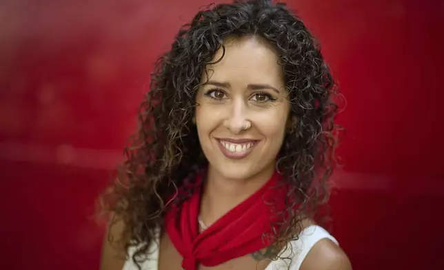Bull-runner Omara Martinez poses for a portrait during the San Fermín festival in Pamplona, northern Spain, on Friday, July 11, 2025. (AP Photo/Miguel Oses)