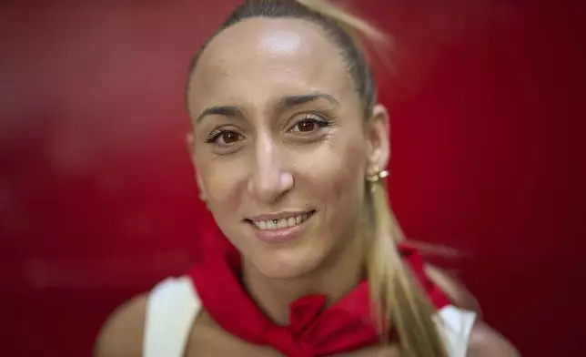 Bull-runner Paula Lopez poses for a portrait during the San Fermín festival in Pamplona, northern Spain, on Friday, July 11, 2025. (AP Photo/Miguel Oses)