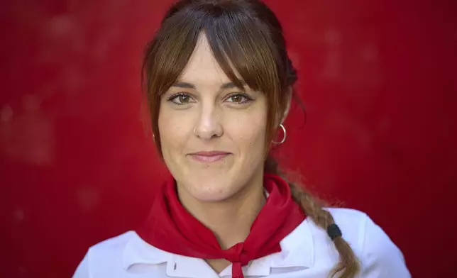 Bull-runner Sara Puñal poses for a portrait during the San Fermín festival in Pamplona, northern Spain, on Friday, July 11, 2025. (AP Photo/Miguel Oses)