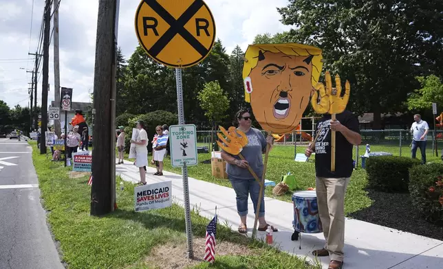 Protesters demonstrate ahead of an event with Vice President JD Vance in West Pittston, Pa., Wednesday, July 16, 2025. (AP Photo/Matt Rourke)