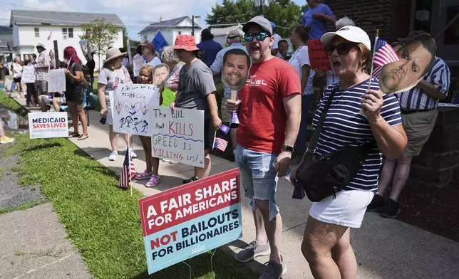 Protesters demonstrate ahead of an event with Vice President JD Vance in West Pittston, Pa., Wednesday, July 16, 2025. (AP Photo/Matt Rourke)