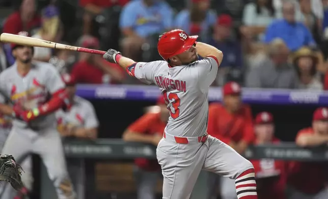 St. Louis Cardinals' Garrett Hampson flies out against Colorado Rockies relief pitcher Jake Bird in the ninth inning of a baseball game Monday, July 21, 2025, in Denver. (AP Photo/David Zalubowski)