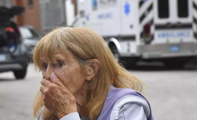 Donna Murphy, a resident at the Gabriel House assisted living facility, in Fall River, Mass., speaks with members of the media outside a temporary shelter, Monday, July 14, 2025, in Fall River, Mass., following a fire at the Gabriel House that started late Sunday and resulted in multiple fatalities. (AP Photo/Steven Senne)