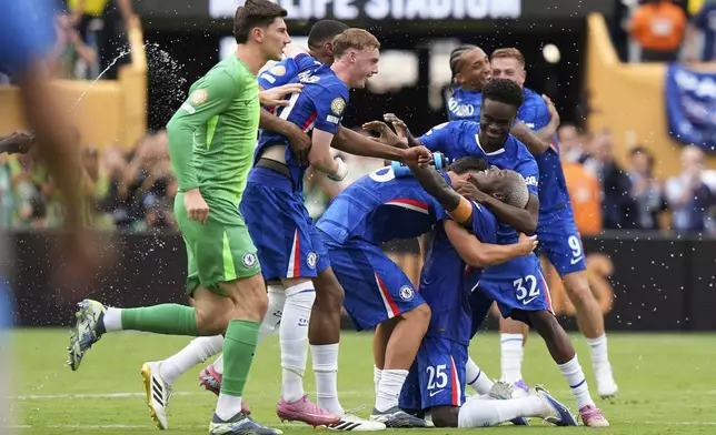 Chelsea players celebrate after winning the Club World Cup final soccer match against Paris Saint-Germain in East Rutherford, N.J., Sunday, July 13, 2025. (AP Photo/Frank Franklin II)