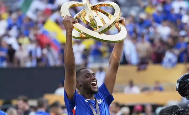 Chelsea's Tosin Adarabioyo hold throphy after the Club World Cup final soccer match between Chelsea and PSG in East Rutherford, N.J., Sunday, July 13, 2025. (AP Photo/Chris Szagola)