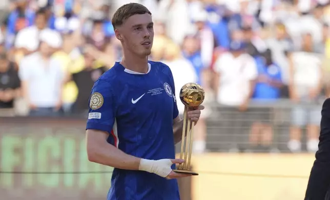 Chelsea's Cole Palmer (10) holds the golden ball trophy following the Club World Cup final soccer match between Chelsea and PSG in East Rutherford, N.J., Sunday, July 13, 2025. (AP Photo/Seth Wenig)