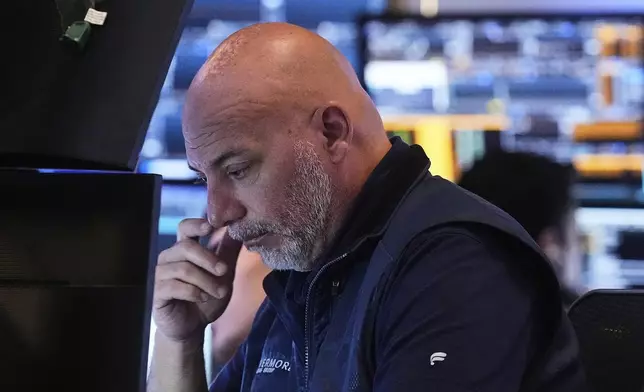 Trader Vincent Napolitano works on the floor of the New York Stock Exchange, Friday, July 18, 2025. (AP Photo/Richard Drew)