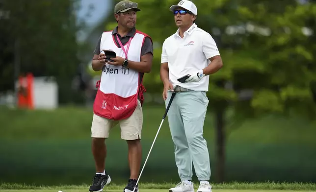 Kurt Kitayama, right, stands with his caddie, Daniel Kitayama, at the tenth tee during the final round of the 3M Open golf tournament at the Tournament Players Club Sunday, July 27, 2025, in Blaine, Minn. (AP Photo/Abbie Parr)