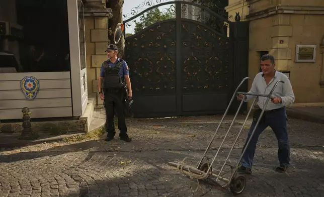A policeman stands guard outside of the Iranian consulate as European and Iranian diplomats meet for talks over Tehran's nuclear program, in Istanbul, Turkey, Friday, July 25, 2025. (AP Photo/Francisco Seco)