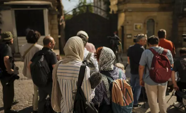 Journalists wait outside of the Iranian consulate, in Istanbul, Turkey, Friday, July 25, 2025, ahead of a meeting between European and Iranian diplomats for talks over Tehran's nuclear program. (AP Photo/Francisco Seco)
