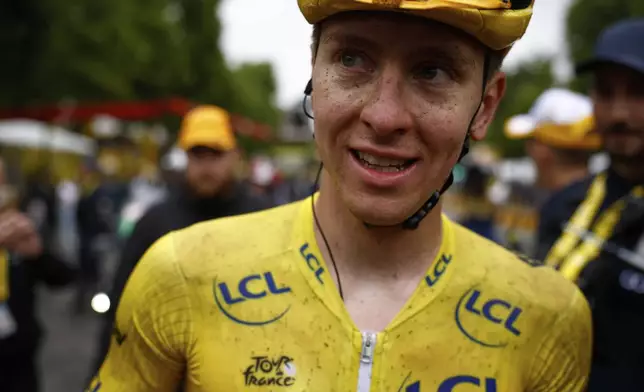 Slovenia's Tadej Pogacar, the Tour de France winner, smiles after finishing, the twenty-first stage of the Tour de France cycling race over 132.3 kilometers (82.1 miles) with start in Mantes-la-Ville and finish on the Champs-Elysees in Paris, France, Sunday, July 27, 2025. (Yoan Valat, Pool Photo via AP)