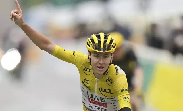 Tour de France winner Tadej Pogacar of Slovenia crosses the finish line of the twenty-first stage of the Tour de France cycling race over 132.3 kilometers (82.1 miles) with start in Mantes-la-Ville and finish on the Champs-Elysees in Paris, France, Sunday, July 27, 2025. (AP Photo/Thibault Camus)