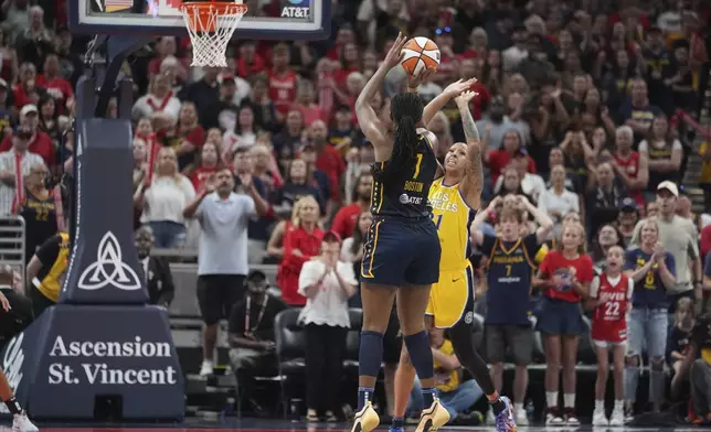 Indiana Fever's Aliyah Boston (7) misses the game tying shot against Los Angeles Sparks' Mercedes Russell (21) during the second half of a WNBA basketball game, Saturday, July 5, 2025, in Indianapolis. (AP Photo/Michael Conroy)