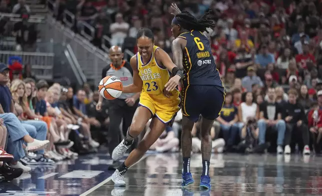 Los Angeles Sparks' Azura Stevens (23) goes by Indiana Fever's Natasha Howard (6) during the second half of a WNBA basketball game, Saturday, July 5, 2025, in Indianapolis. (AP Photo/Michael Conroy)