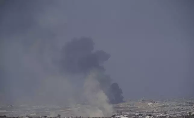 Smoke from an Israeli bombardment rises over the Gaza Strip, seen from southern Israel, Sunday, July 6, 2025. (AP Photo/Ohad Zwigenberg)