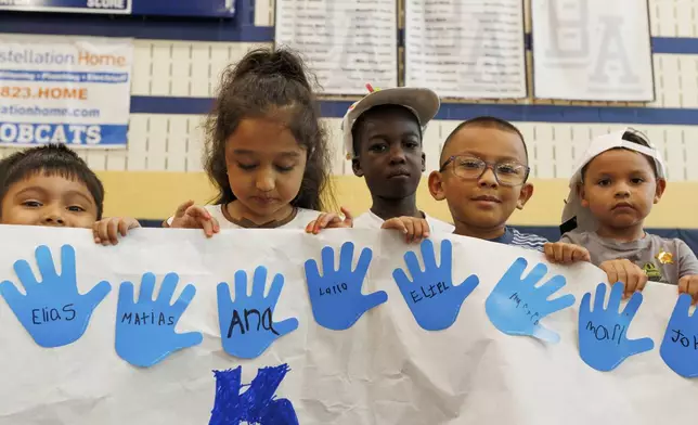 LASOS summer campers hold up an art project at Bel Air High School in Bel Air, Md., on Thursday, July 24, 2025. (AP Photo/KT Kanazawich)
