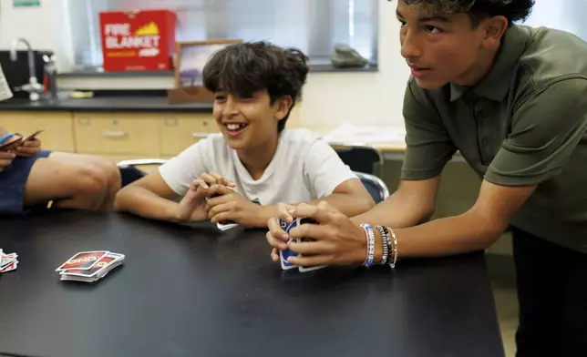 Attendees of LASOS summer camp play a game of Uno at Bel Air High School in Bel Air, Md., on Thursday, July 24, 2025. (AP Photo/KT Kanazawich)