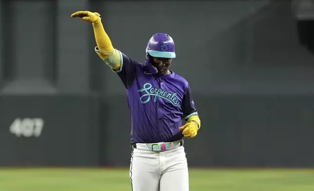 Arizona Diamondbacks' Geraldo Perdomo celebrates his two-run single against the St. Louis Cardinals during the second inning of a baseball game Friday, July 18, 2025, in Phoenix. (AP Photo/Ross D. Franklin)
