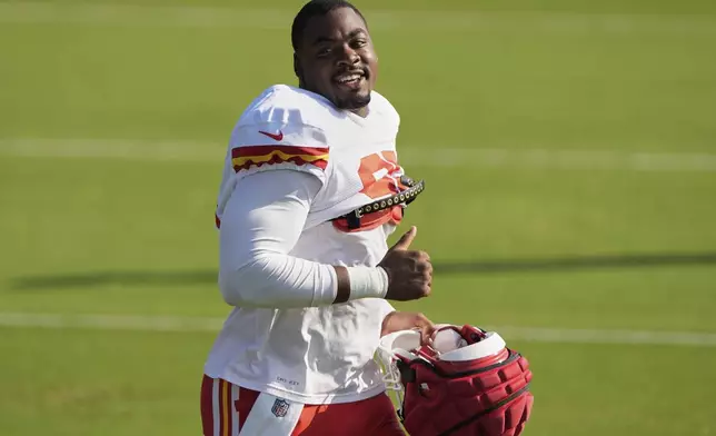 Kansas City Chiefs defensive tackle Chris Jones acknowledges fans as he jogs between drills during Back Together Weekend at the team's NFL football training camp, Sunday, July 27, 2025, in St. Joseph, Mo. (AP Photo/Charlie Riedel)
