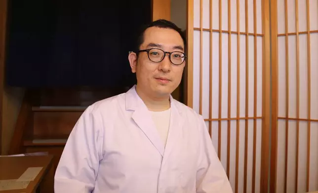 Yoshihiro Kobayashi appears at his store called Tsukushin, which offers a traditional Japanese preserved food called tsukudani in Tsukuda, Tokyo on June 18, 2025. (AP Photo/Yuri Kageyama)