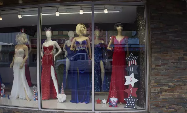 Patriotic themed dresses are displayed in a store window in downtown McAllen, Texas, in the Rio Grande Valley, Tuesday, June 17, 2025. (AP Photo/Jacquelyn Martin)