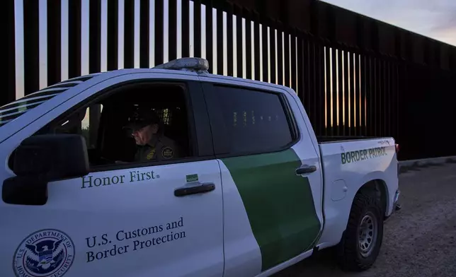 A border patrol agent works by a section of the border wall, Wednesday, June 18, 2025, in Mission, Texas. (AP Photo/Jacquelyn Martin)