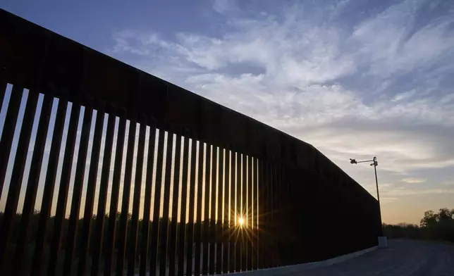 The sun sets over a section of the border wall, Wednesday, June 18, 2025, in Mission, Texas. (AP Photo/Jacquelyn Martin)