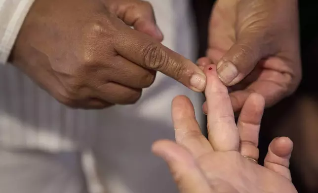 A drop of blood is drawn to measure glucose levels and screen for diabetes during a health clinic at Holy Family Services, a birth center and women's clinic in the Rio Grande Valley, Wednesday, June 18, 2025, in Weslaco, Texas. (AP Photo/Jacquelyn Martin)