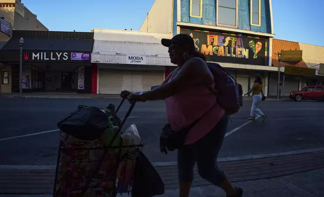 Women walk through downtown McAllen, Texas, in the Rio Grande Valley, Tuesday, June 17, 2025. (AP Photo/Jacquelyn Martin)