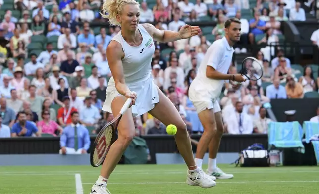 Katerina Siniakova of Czech Republic returns as Sem Verbeek of the Netherlands watches during the mixed doubles final match against Joe Salisbury of Britain and Luisa Stefani of Brazil at the Wimbledon Tennis Championships in London, Thursday, July 10, 2025.(AP Photo/Kirsty Wigglesworth)