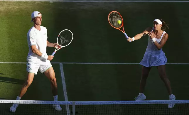 Joe Salisbury of Britain and Luisa Stefani of Brazil return the ball during the mixed doubles final match against Sem Verbeek of Netherland and Katerina Siniakova of Czech Republic at the Wimbledon Tennis Championships in London, Thursday, July 10, 2025. (AP Photo/Joanna Chan)