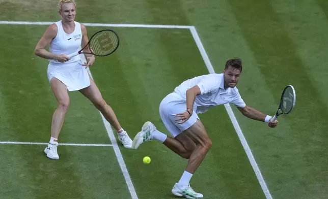 Sem Verbeek of Netherland and Katerina Siniakova of Czech Republic return during the mixed doubles final match against Joe Salisbury of Britain and Luisa Stefani of Brazil at the Wimbledon Tennis Championships in London, Thursday, July 10, 2025. (AP Photo/Joanna Chan)