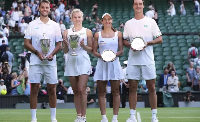 Winner Sem Verbeek of the Netherlands, left, and Katerina Siniakova of Czech Republic, second left, celebrate with the trophy after winning the mixed doubles final match against Joe Salisbury of Britain, right, and Luisa Stefani of Brazil, secoond right, at the Wimbledon Tennis Championships in London, Thursday, July 10, 2025.(AP Photo/Kirsty Wigglesworth)