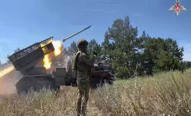 In this photo taken from video distributed by Russian Defense Ministry Press Service on Wednesday, July 23, 2025, a Russian Army BM-21 "Grad" self-propelled 122 mm multiple rocket launcher fires towards Ukrainian position in an undisclosed location in Ukraine. (Russian Defense Ministry Press Service via AP)
