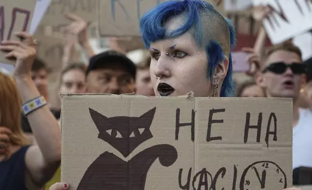 Participants hold banners during a protest against a law targeting anti-corruption institutions in central Kyiv, Ukraine, Wednesday, July 23, 2025. (AP Photo/Efrem Lukatsky)