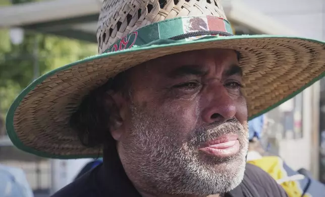 Juan Duran cries outside of Glass House Farms, where a relative was injured during a previous day immigration raid, on Friday, July 11, 2025, in Camarillo, Calif. (AP Photo/Damian Dovarganes)