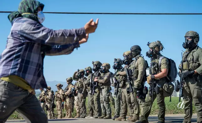 EDS NOTE: OBSCENITY - Protesters standoff against federal immigration agents during a raid in the agriculture area of Camarillo, Calif., Thursday, July 10, 2025. (AP Photo/Michael Owen Baker)