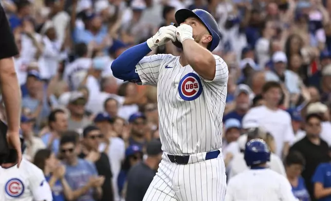 Chicago Cubs' Michael Busch kisses his hands after hitting a home run against the Boston Red Sox, during the first inning of a baseball game, Saturday, July 19, 2025, in Chicago. (AP Photo/Matt Marton)