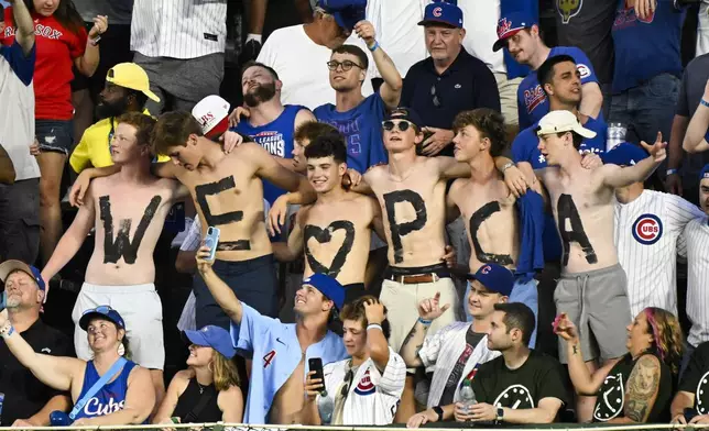 Chicago Cubs fans show their feelings for outfielder Pete Crow-Armstrong during the seventh inning stretch of a baseball game against the Boston Red Sox, Saturday, July 19, 2025, in Chicago. (AP Photo/Matt Marton)