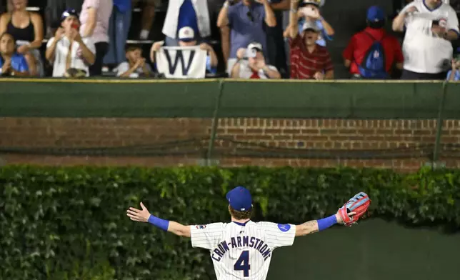 Chicago Cubs outfielder Pete Crow-Armstrong (4) greets fans after a baseball game against the Boston Red Sox, Saturday, July 19, 2025, in Chicago. (AP Photo/Matt Marton)