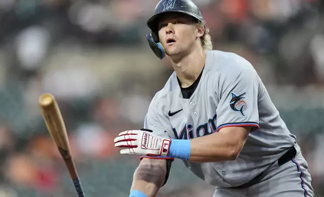 Miami Marlins' Kyle Stowers tosses his bat after being walked by Baltimore Orioles starting pitcher Dean Kremer during the fourth inning of a baseball game Friday, July 11, 2025, in Baltimore. (AP Photo/Stephanie Scarbrough)