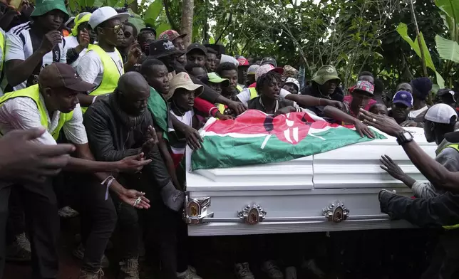 Boniface Kariuki, a vendor who was shot at close range by a police officer during last month's protests, is laid to rest at her parents' farm in Kangema, Muranga County, Kenya, Friday, July 11, 2025. (AP Photo/Brian Inganga)