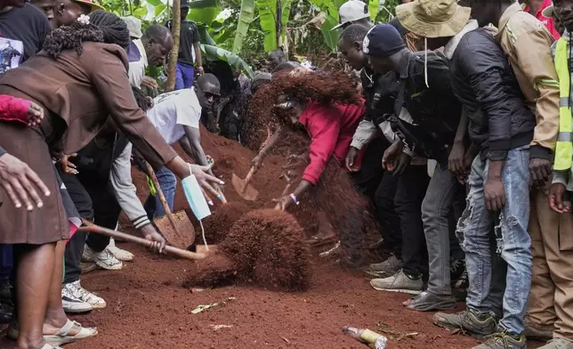 Mourners bury Boniface Kariuki, a vendor who was shot at close range by a police officer during last month's protests, in Kangema, Muranga County, Kenya, Friday, July 11, 2025. (AP Photo/Brian Inganga)