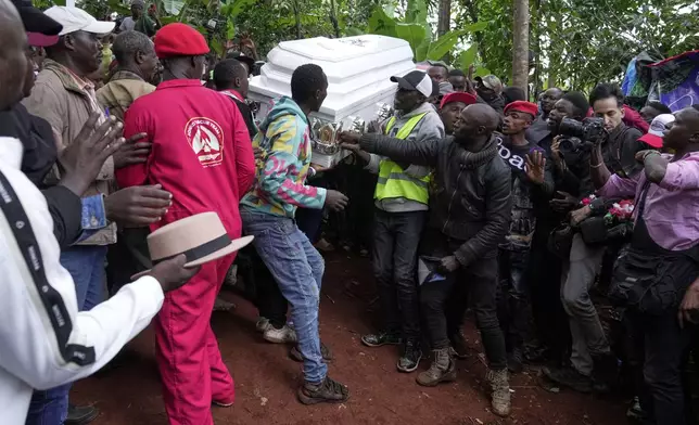 Mourners carry the casket of vendor Boniface Kariuki, who was shot at close range by a police officer during last month's protests, to be laid to rest at her parents' farm in Kangema, Muranga County, Kenya, Friday, July 11, 2025. (AP Photo/Brian Inganga)