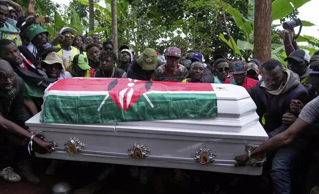 Boniface Kariuki, a vendor who was shot at close range by a police officer during last month's protests, is laid to rest at her parents' farm in Kangema, Muranga County, Kenya, Friday, July 11, 2025. (AP Photo/Brian Inganga)
